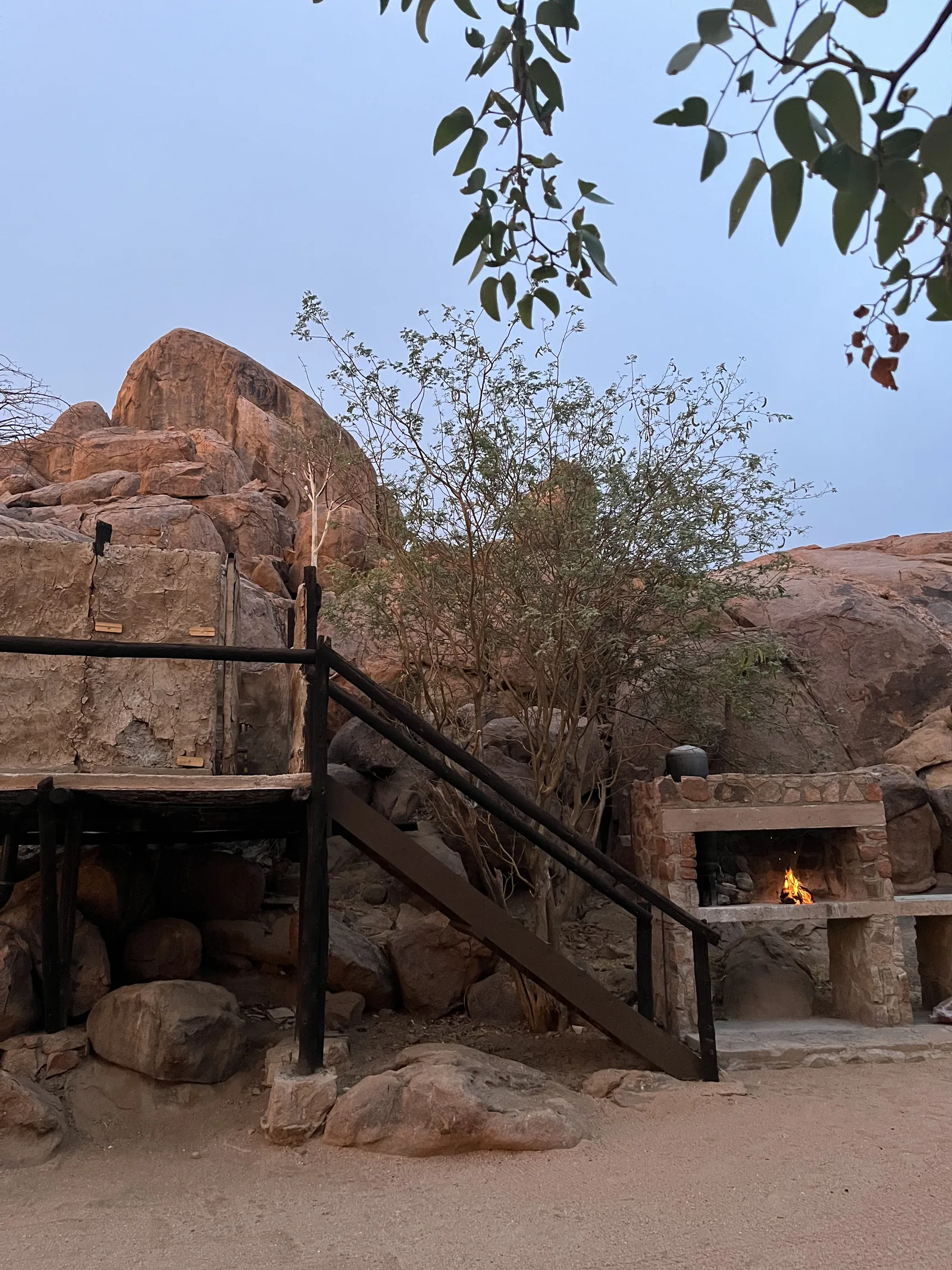 A Private Campsite braai and elevated bathroom at dusk.