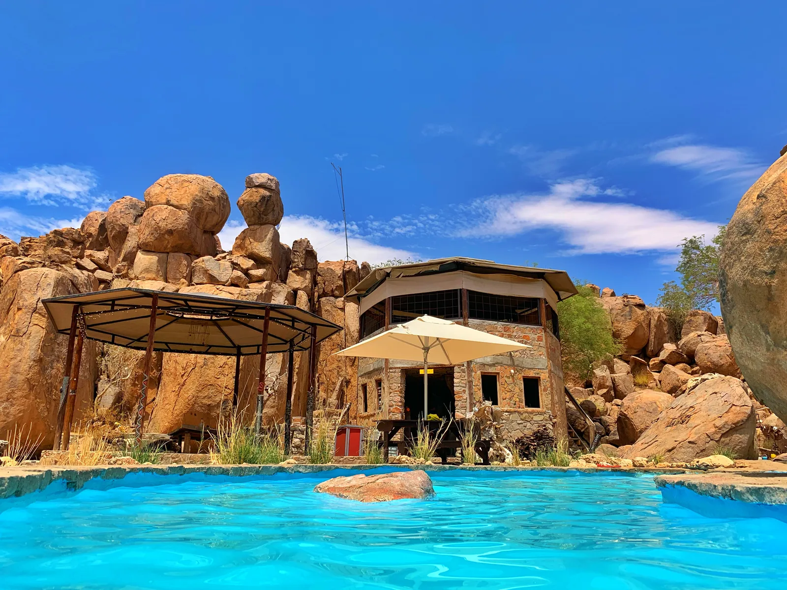 The rock pool, bar and granite boulders at Madisa Camp.